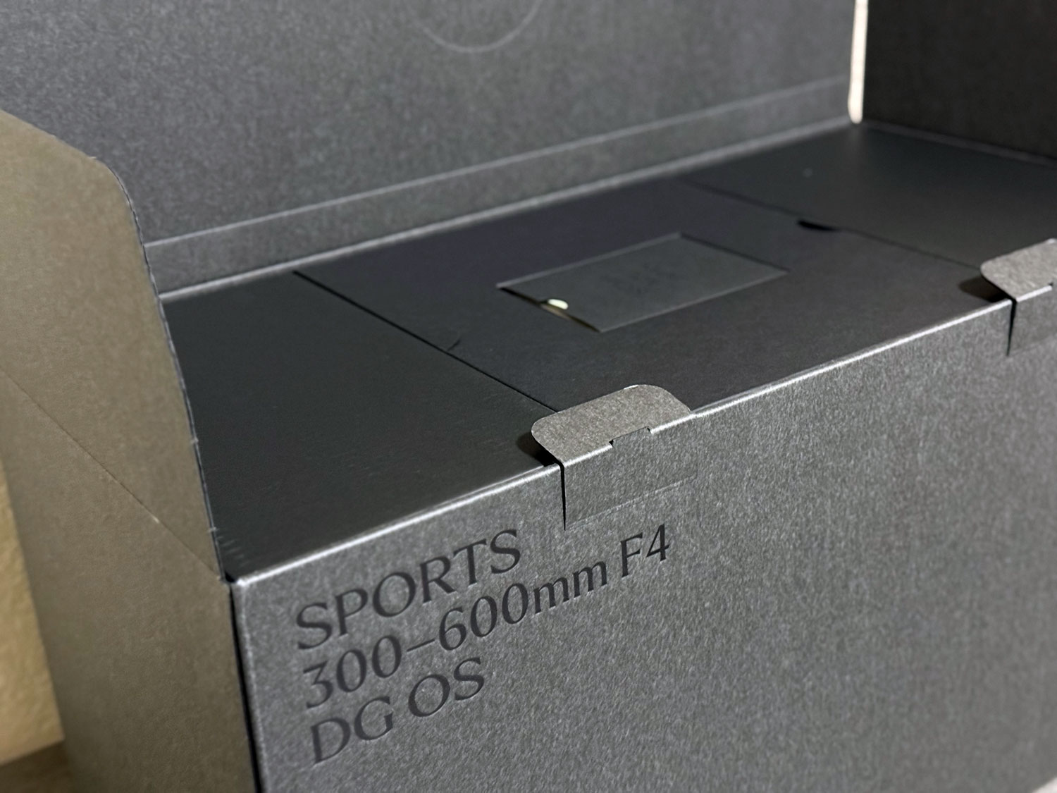 Sigma 300–600mm f/4 Sports lens inside its custom black packaging